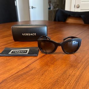 Versace black sunglasses with gold emblem on both sides